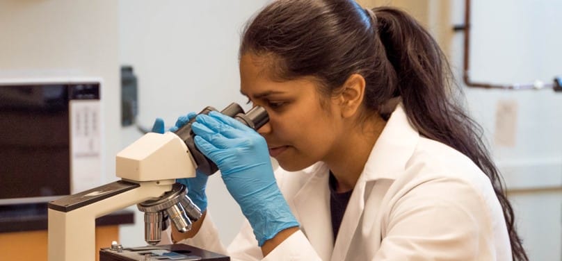 Woman scientist using microscope