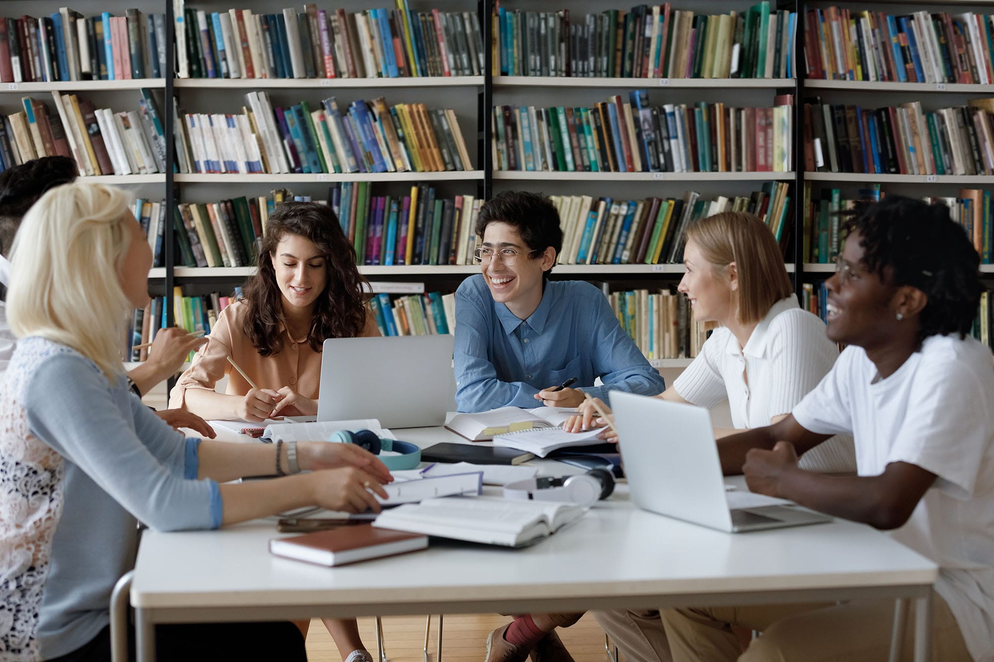 Diverse student group in discussion with library background